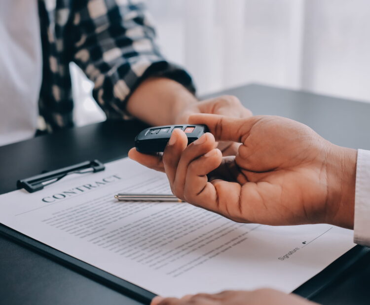 Auto negotiation experts helping a buyer at a car dealership