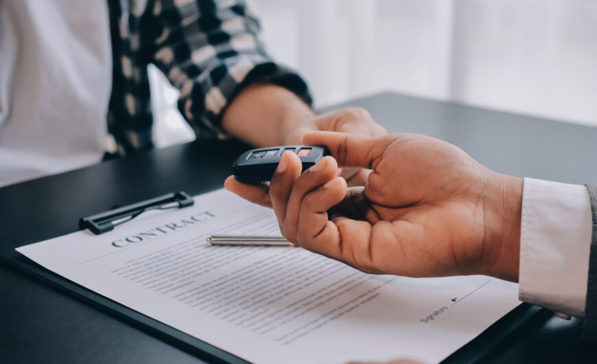 Auto negotiation experts helping a buyer at a car dealership
