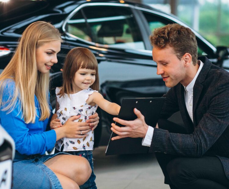 Family buying an SUV to save money with smart car financing and best SUV deals